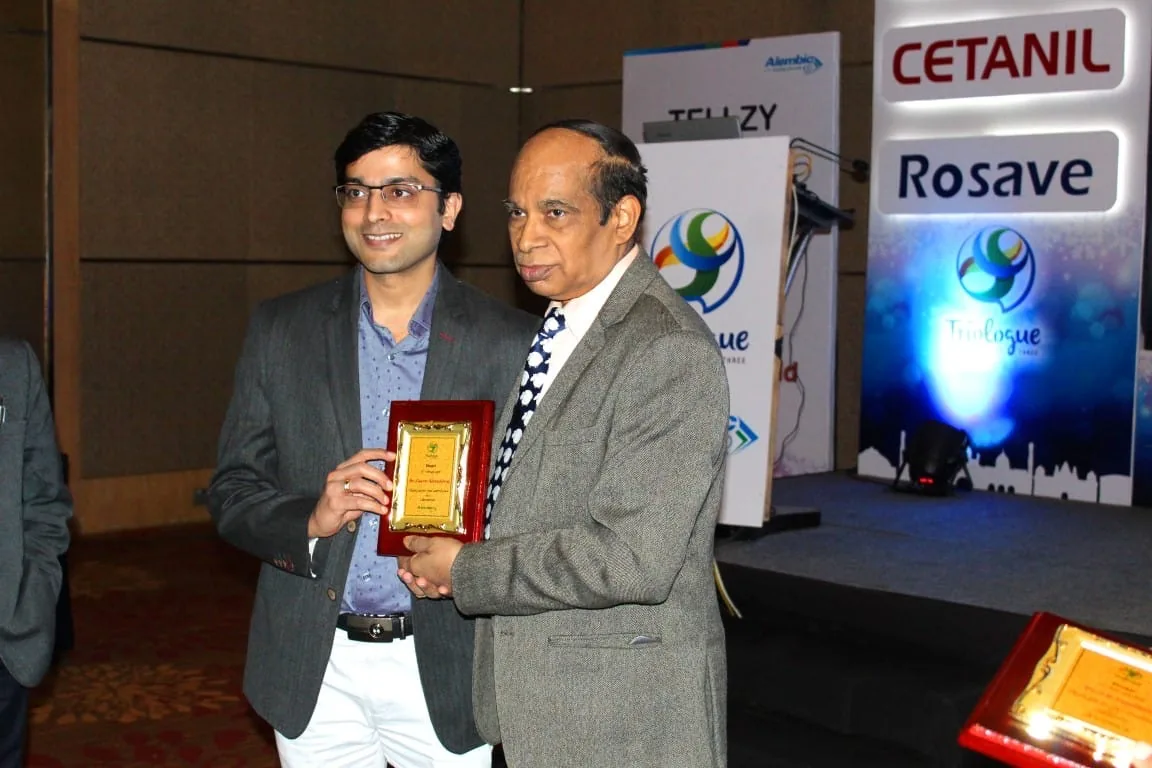 Dr. Gaurav Khandelwal receiving a professional award plaque